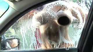 Sexy and wet girl washing car gives a good boobjob