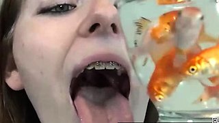 Pretty hungry girl swallows innocent fish - Vore
