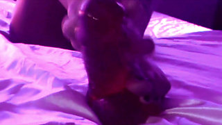 Young Girl Using Her Feet to Play with the Dildo While Masturbating