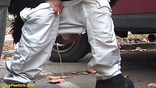 Girl peeing between the cars