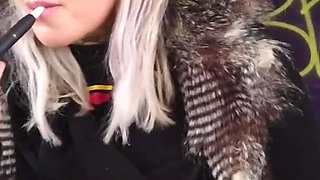 Blonde lady smokes an electronic cigarette