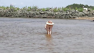 Naked hot MILF on a nude beach.