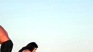 Topless beach girl in blue thong