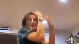 Bella Thorne dancing at home in open shirt.