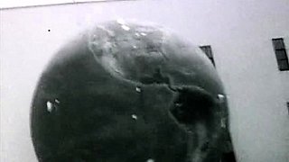 In a kitchen a sexy brunette playing with her big boobs