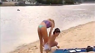 Nude girls outdoor on public beach having fun