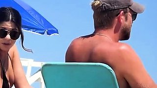 Topless beach girl in blue thong
