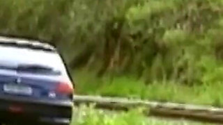 A horny young couple has sex in a car in the middle of nature
