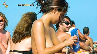 Stunning bare teenagers have fun together at a bare beach