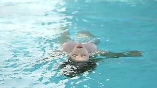 Beautiful Redhead's Playful Charm by the Poolside