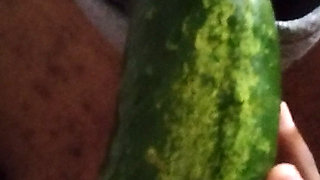 Busty bitch playing with herself and fucking herself with a cucumber