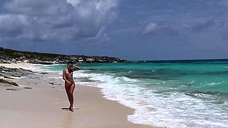 Brunette babe erotica herself on beach