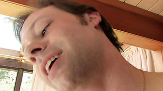 An oiled brunette sprayed on her pussy