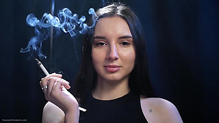 Elegant Brunette Smoking in Black Outfit
