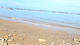 On a nudist beach in Italy, I experienced a rather intense encounter with a very large penis.