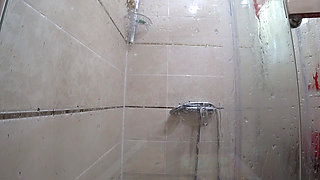 The camera is watching a mature chubby milf in the shower. Gorgeous fat ass, big natural boobs, hairy pussy. PAWG.