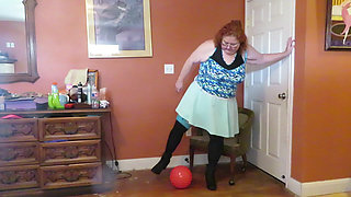 Nurse Vicki  plays with a rubber ball in a mini skirt, sexy stockings and high heel mini boots