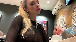 Flashing her big boobs in transparent top in public cafe.