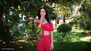 Sultry Brunette in Red Dress Smoking Rolled Cigarette