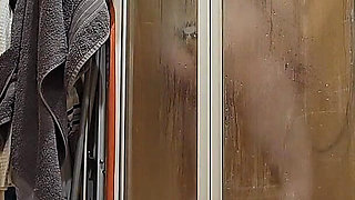 A Busty BBW Showering in the Shower Cabin, Shaving Her Armpits, Pussy, and Legs.