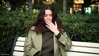 Young Brunette Is Taking an Unhurried Stroll with Allwhite 120mm Cigarette
