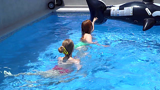 Lesbian Girls Are Having Fun in a Pool with an Inflatable Shark